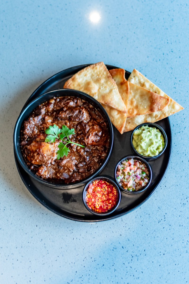 Beef cheek chilli with flatbread and accompaniments