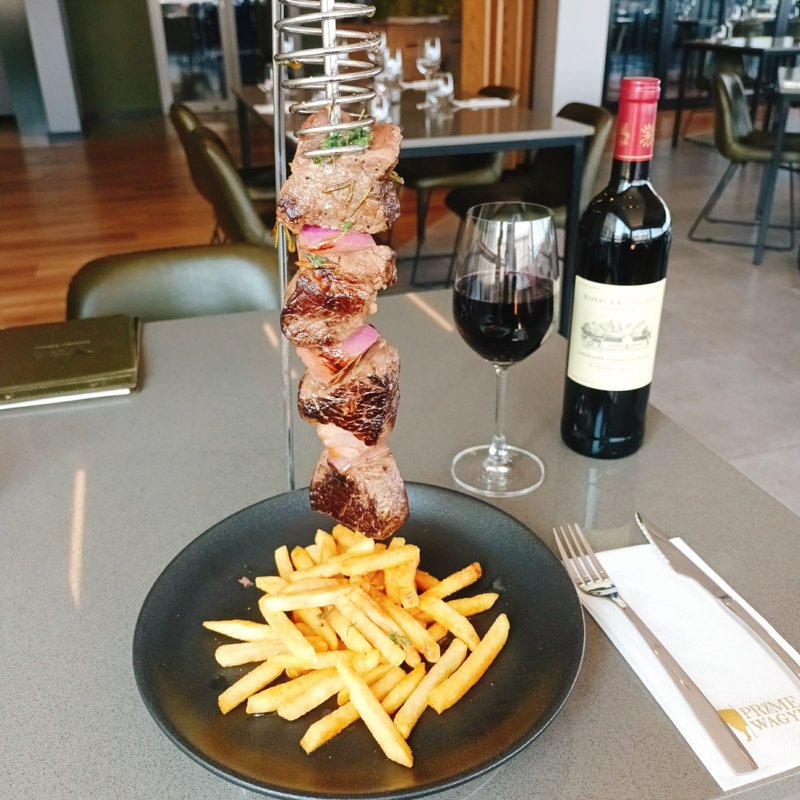 A hanging beef espetada served with fries at Prime Wagyu