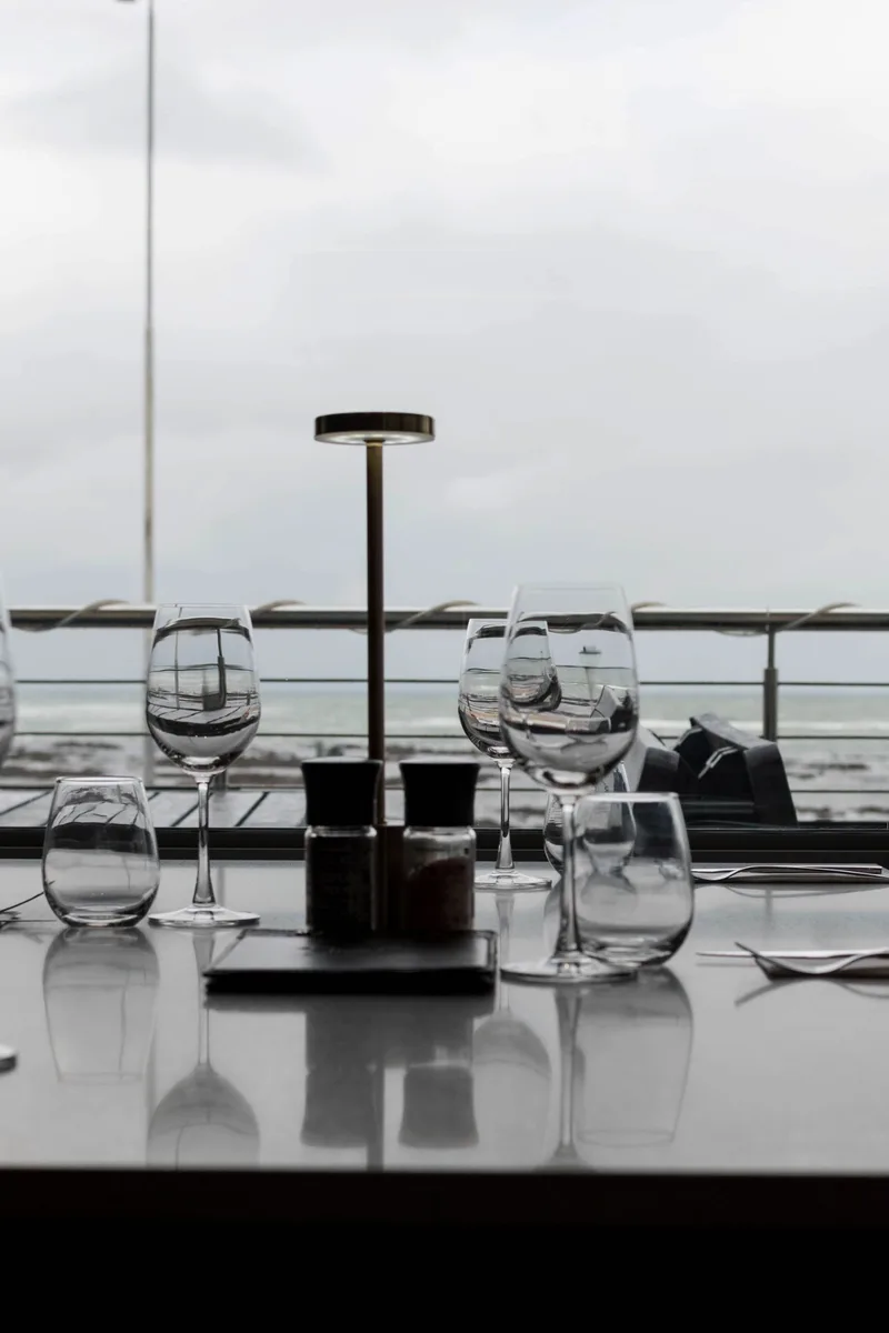 Wine glasses on a table overlooking Strand beach at Prime Wagyu