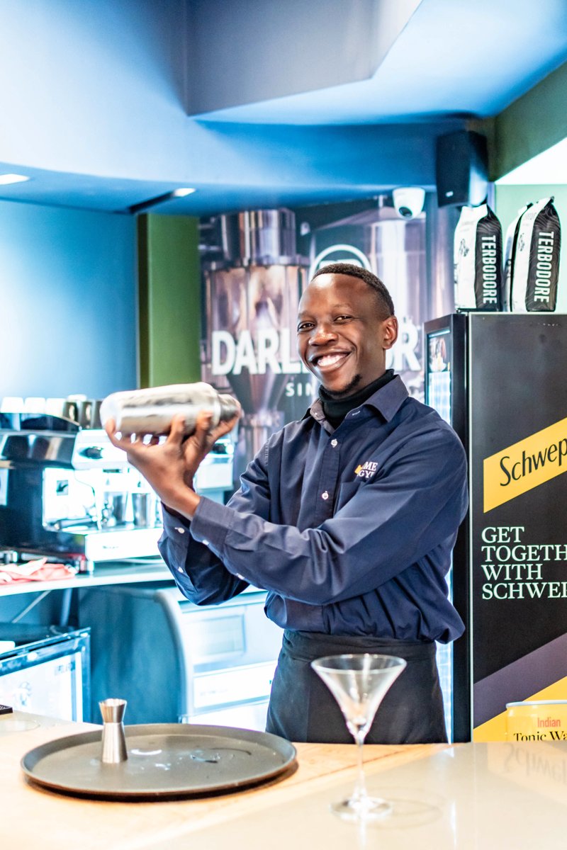 A smiling member of the Prime Wagyu team at the bar